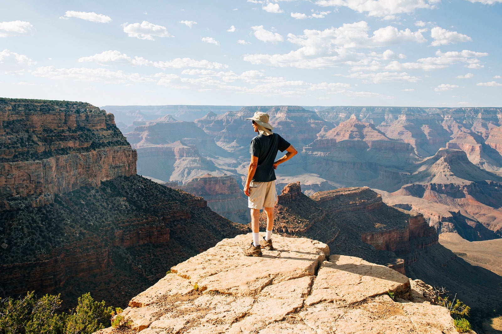 Man looking at view at Grand Canyon, South Rim. Arizona USA