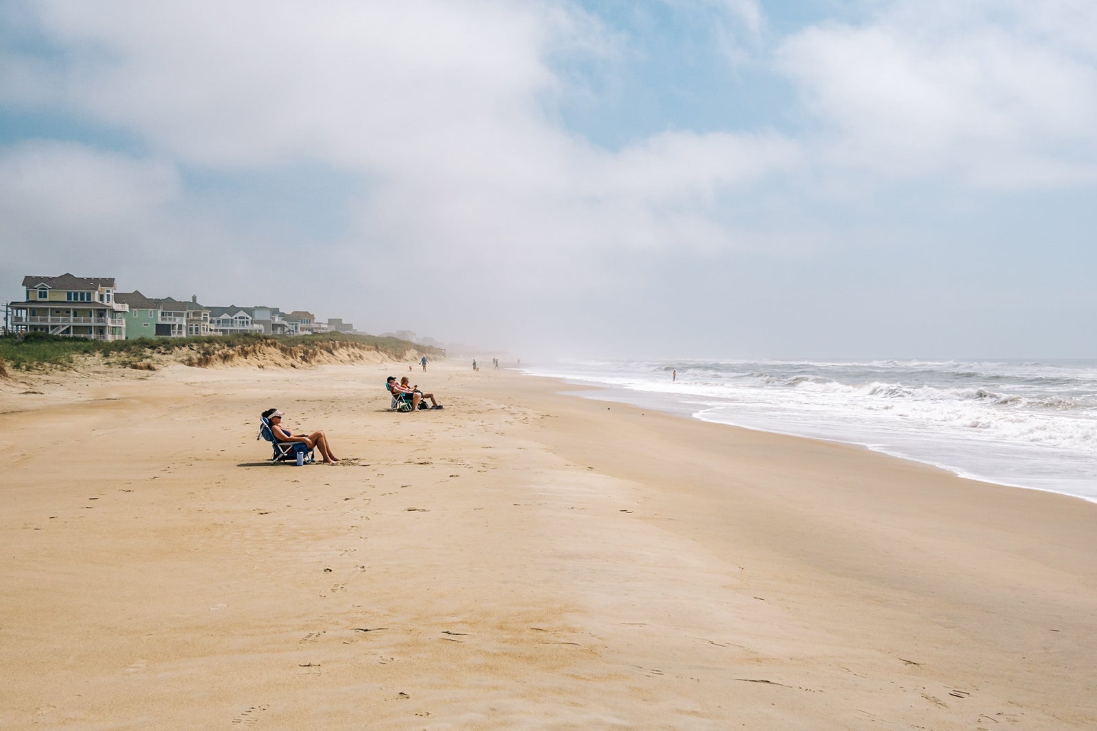 People in beach lounge chairs at Cape Hatteras in North Carolina.