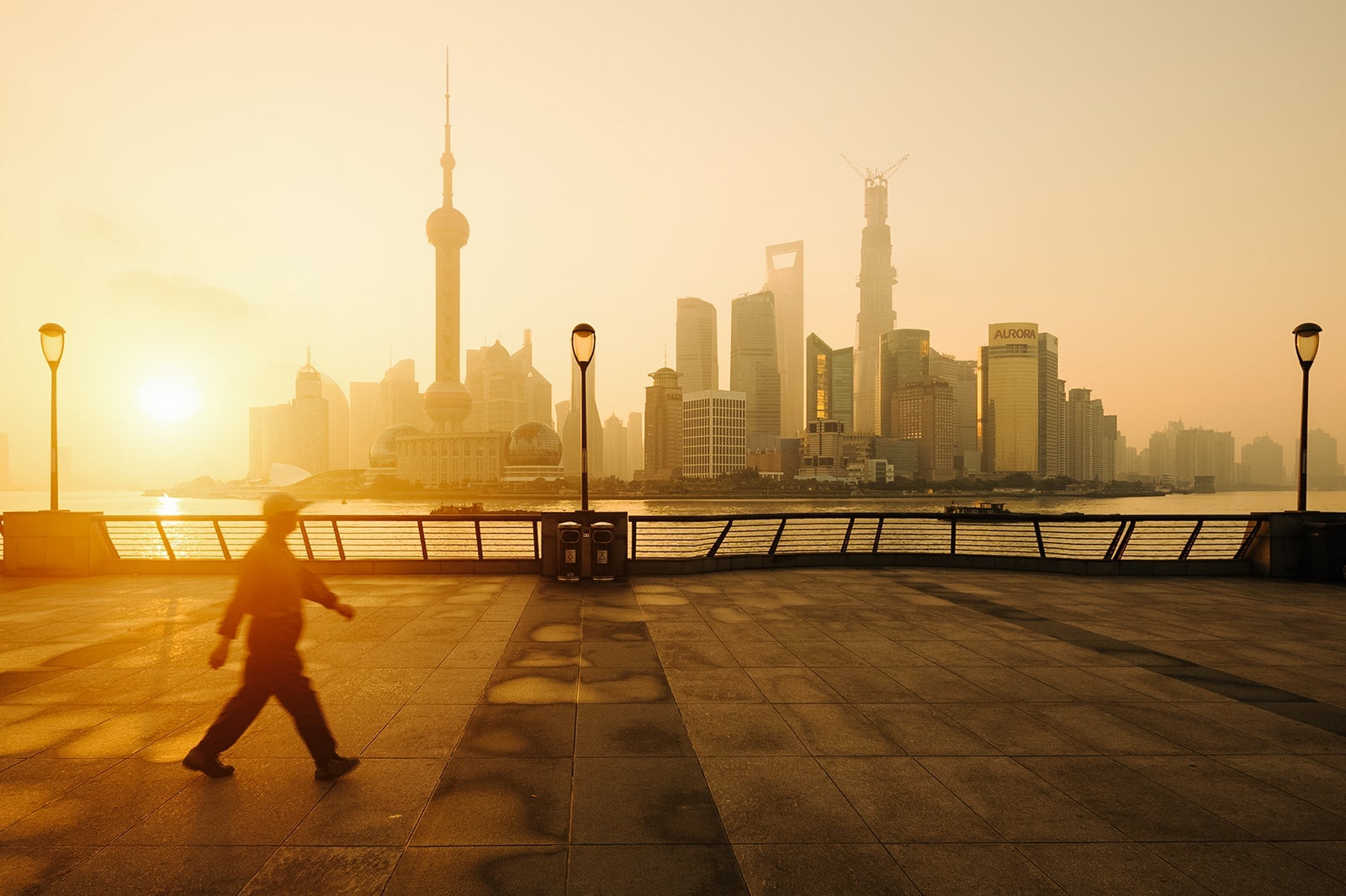 Sunrise on Bund Shanghai with walking man