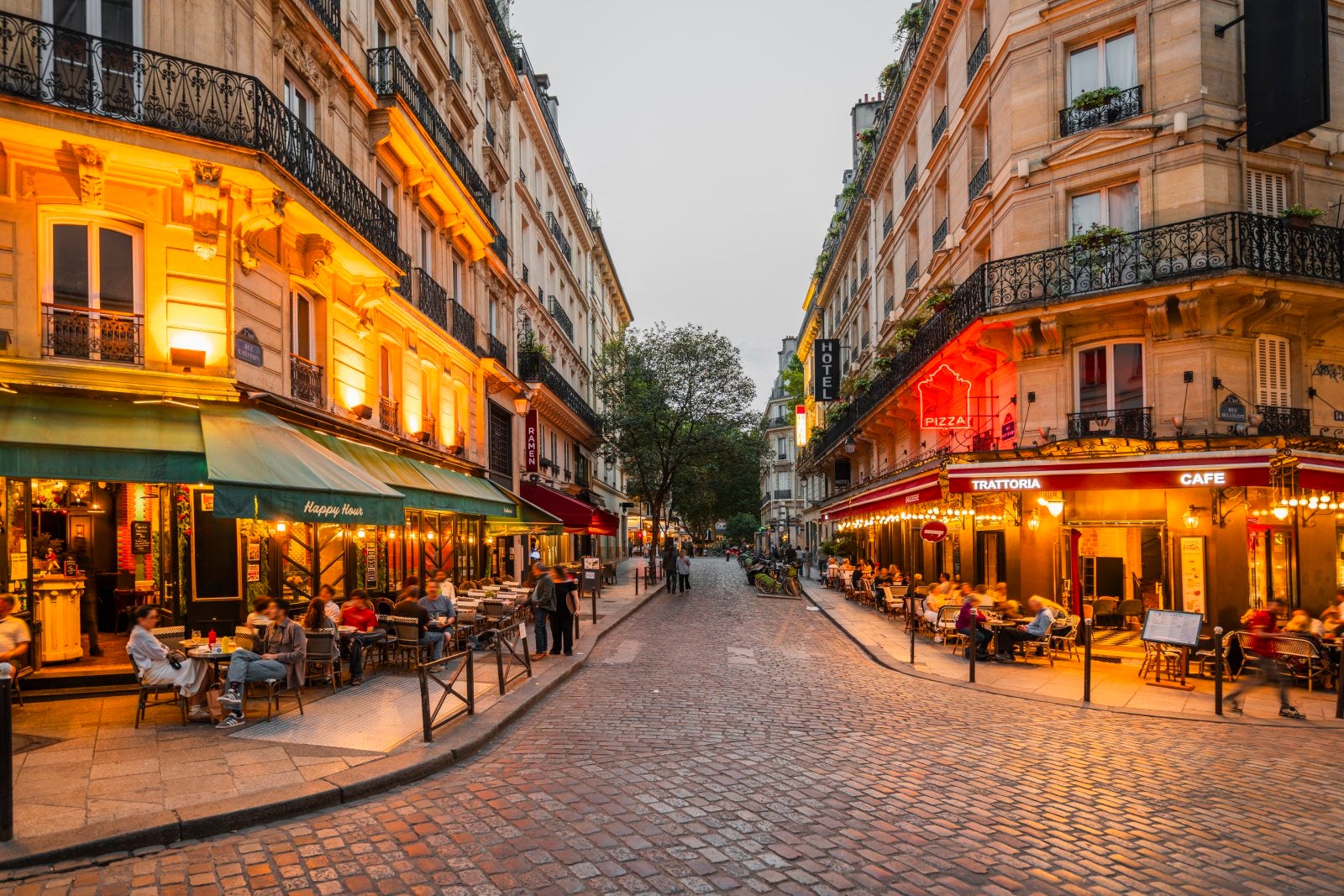 Bustling evening at a charming street with lively cafes and restaurants, Paris, France