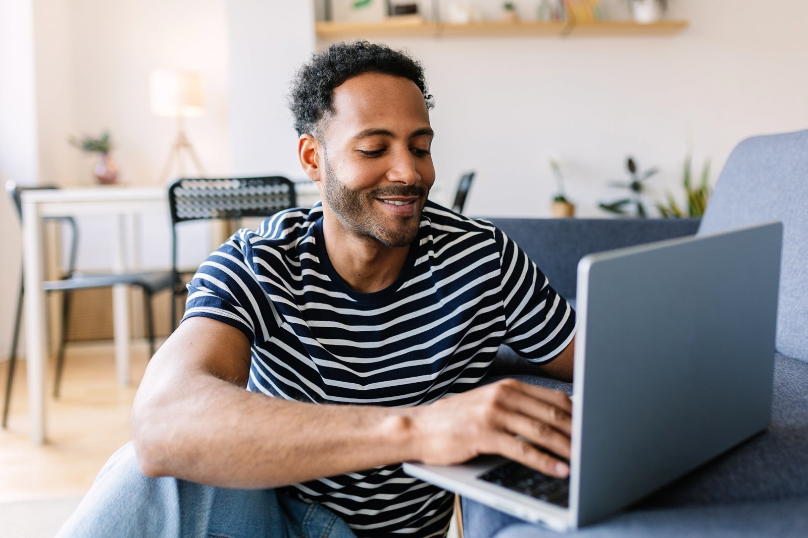 Man uses a laptop at home