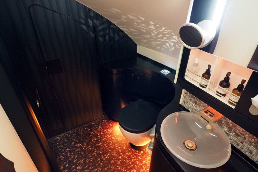 The main first-class lavatory occupies the same space as The Residence bedroom on the other side of the plane.