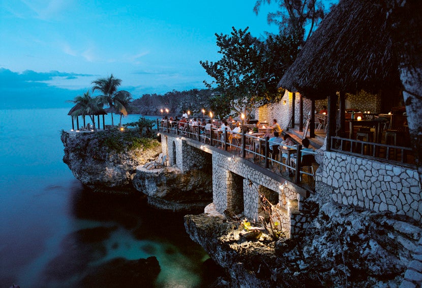 Stay in Rockhouse's Afrian-inspired village carved into volcanic rock along Pristine Cove in Negril.