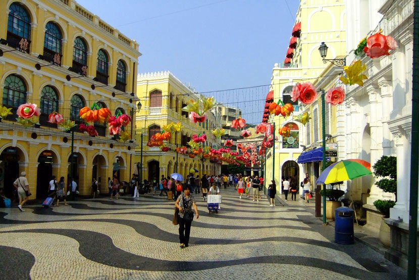 Old Macau's Senado Square is full of fantastically-preserved Portuguese architecture. Image courtesy of <a href="http://www.shutterstock.com/pic-158363639/stock-photo-macau-china-september-19-unidentified-tourists-walk-around-senado-square-on-september-19-2011-in-historic-center-of-macau-china-macaus-economy-is-heavily-dependent-on-tourism-and-g.html?src=Qbk7BmN1_aIESGOWBoyDCA-1-15" target="_blank">Shutterstock</a>.